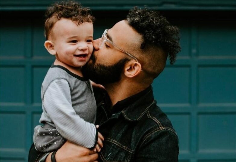 Father holding his baby boy with matching haircut
