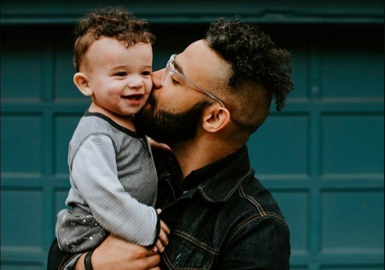 Father holding his baby boy with matching haircut